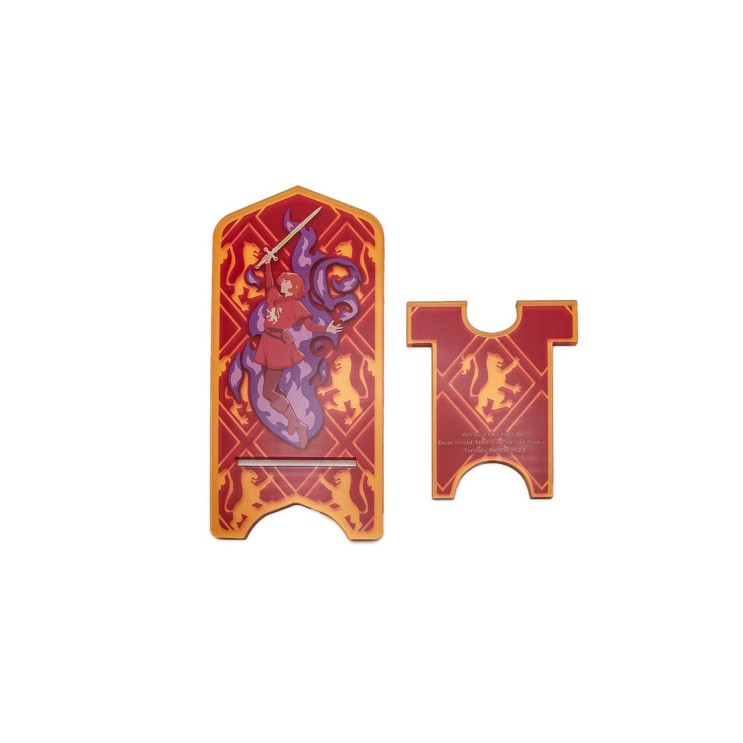 A product photo of a disassembled Alanna Acrylic Phone Standee. The base is removable from the larger standee, and has a lion emblazoned on the center along with credits.