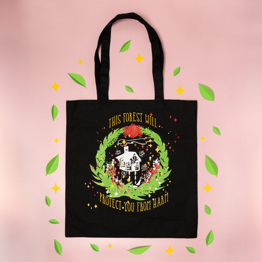 A flat lay photo of the Baba Yaga Tote arranged with papercut green leaves and yellow diamond sparkles.