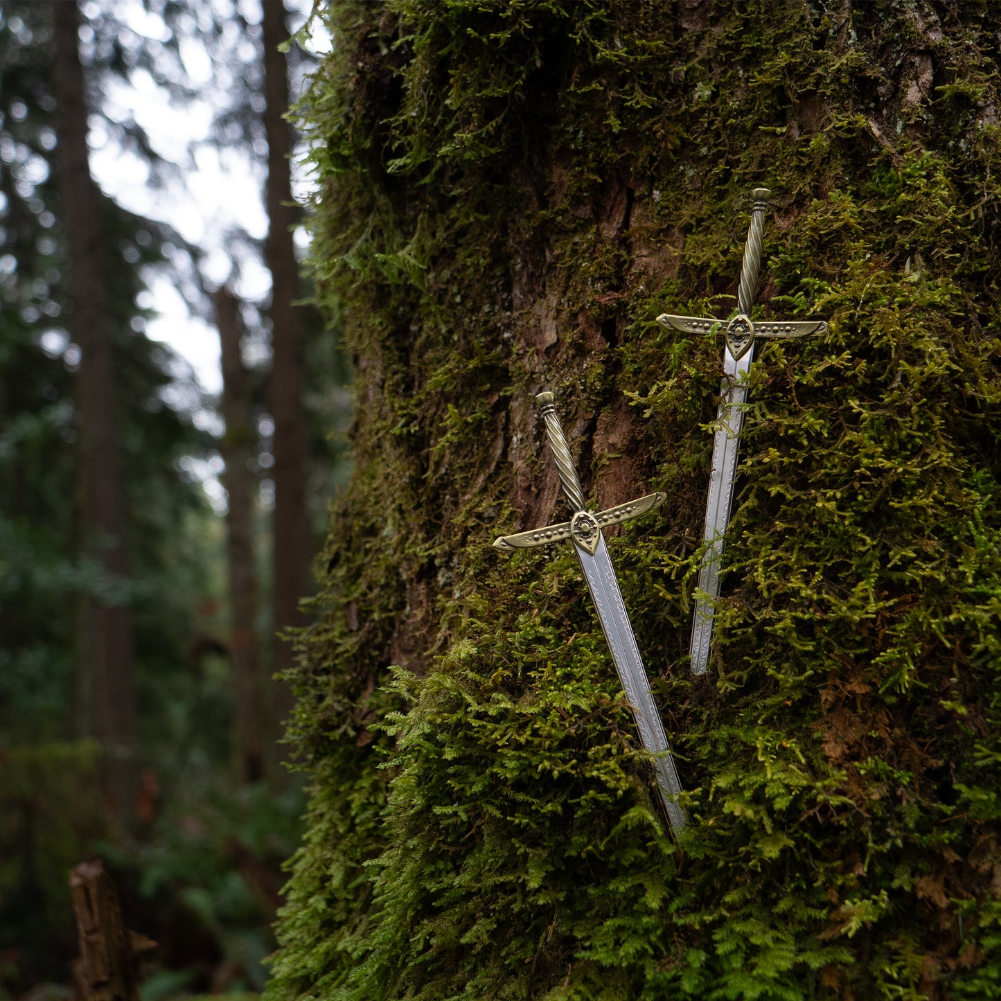 A photograph of two Lightning Mini Swords piercing the moss of a tree.