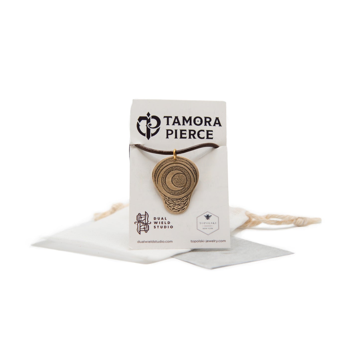 A product photo of the brass pendant with brown cord. The pregnancy charm is an upside-down pear shape with a crescent moon and surrounding circles etched ino the center. Below the moon are small wavey etched lines.