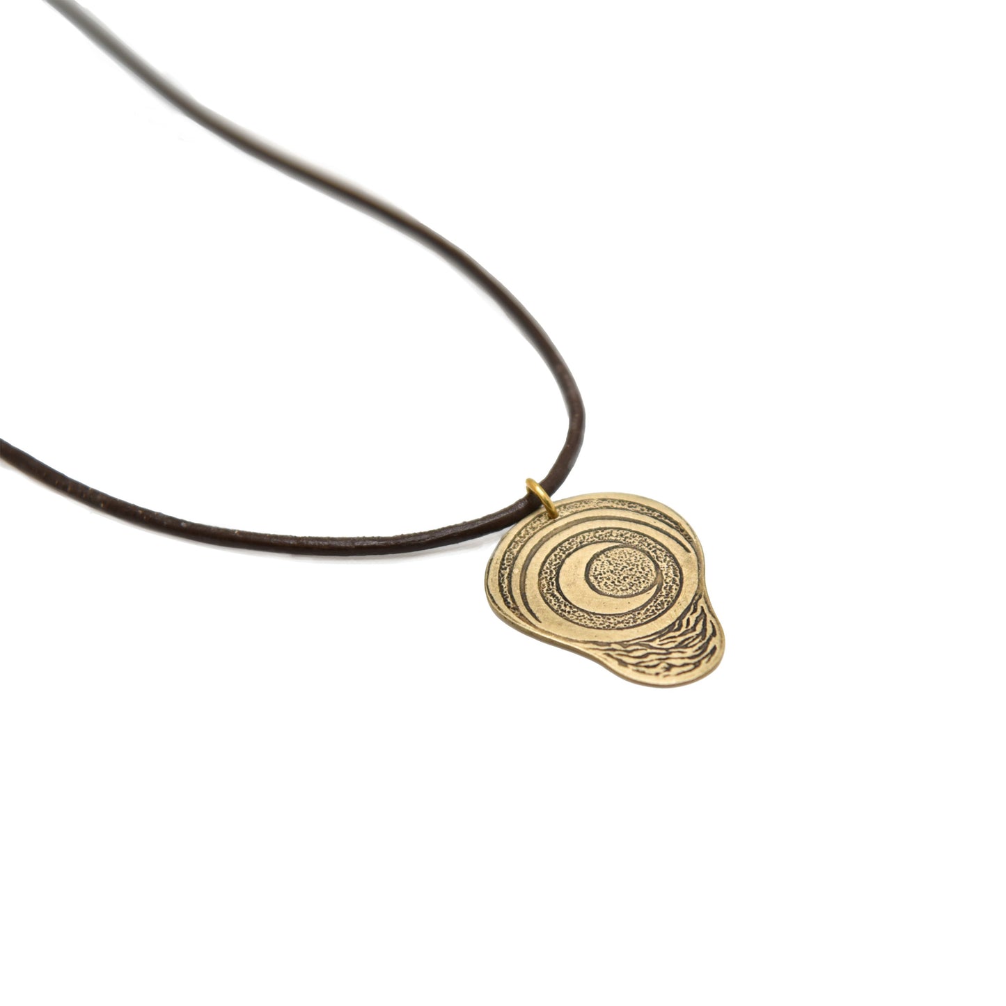A product photo of the pregnancy charm laying at an angle with a brown cord.