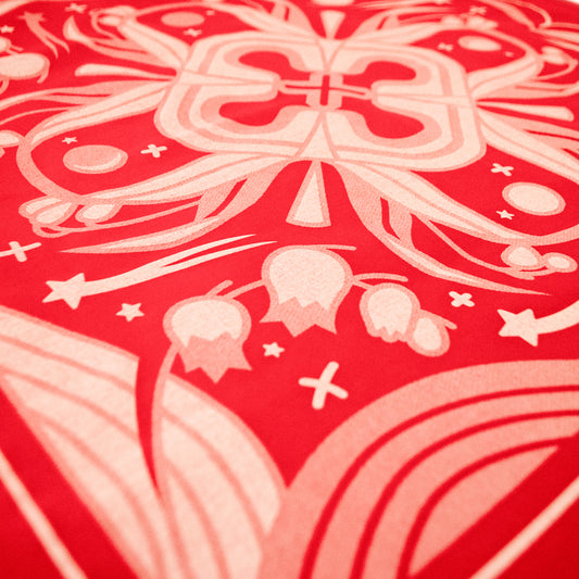 A closeup of the Sacred Blood Bandana, featuring in particular the lily of the valley plant, shooting stars and sparkles.