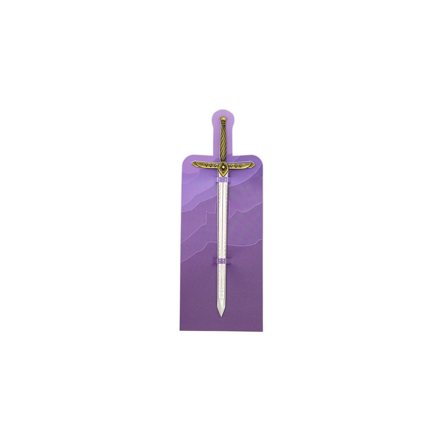 A letter opener sized sword with scrollwork on the nickel blade. The hilt of the mini sword is golden and the sword is sheathed in a paper backing card with purple mountains printed on it.