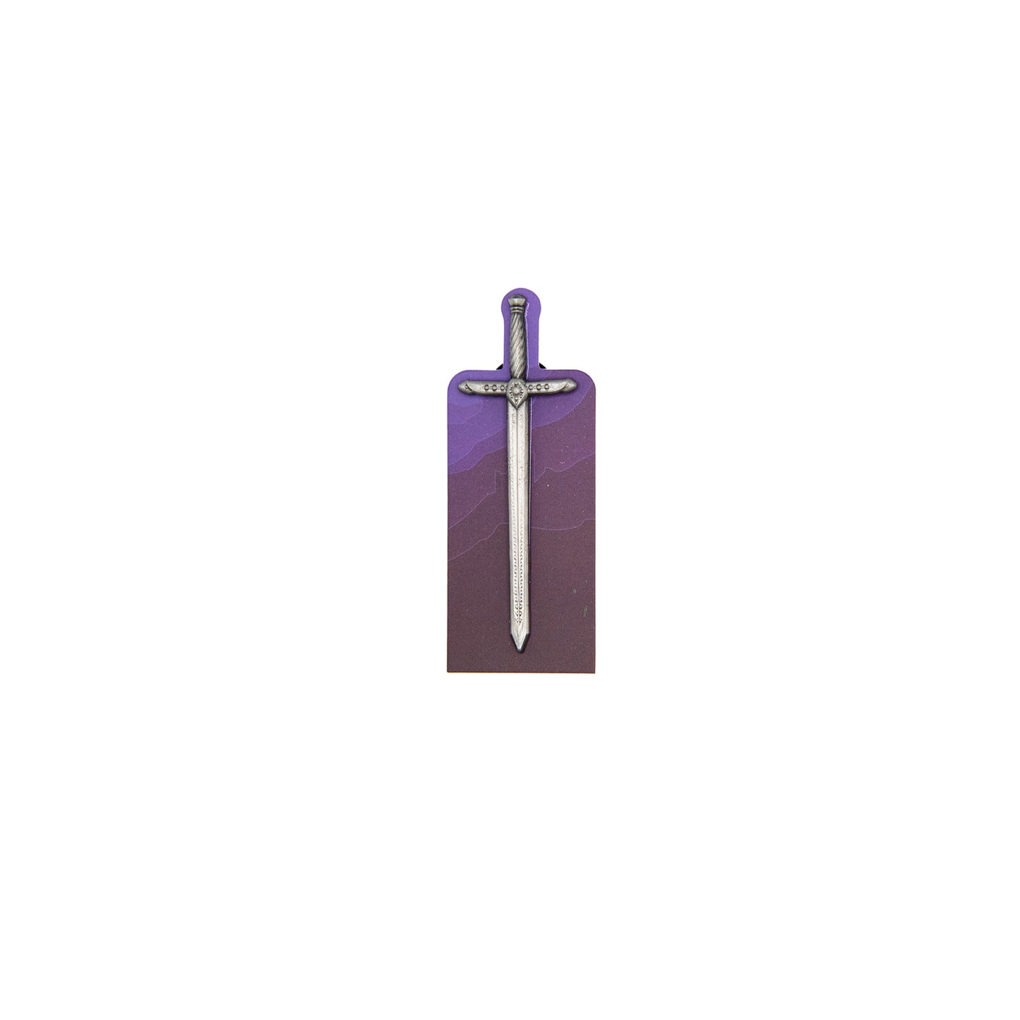 A product photo of the Tamora Pierce Lightning Pin. The pin's hilt is a darker silver while the blade is a brighter nickel. The pin is on its backing card, which depicts a purple mountain range.