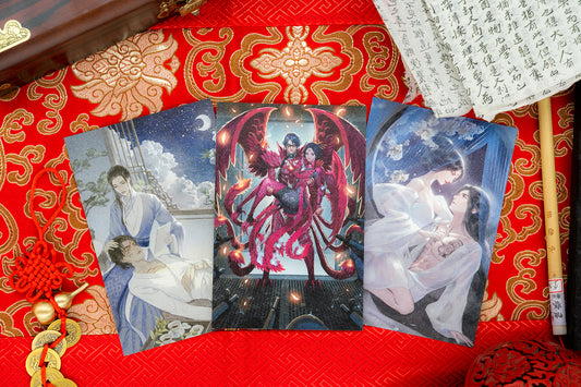 The Iron Trio Postcard set displayed on red and gold silk.