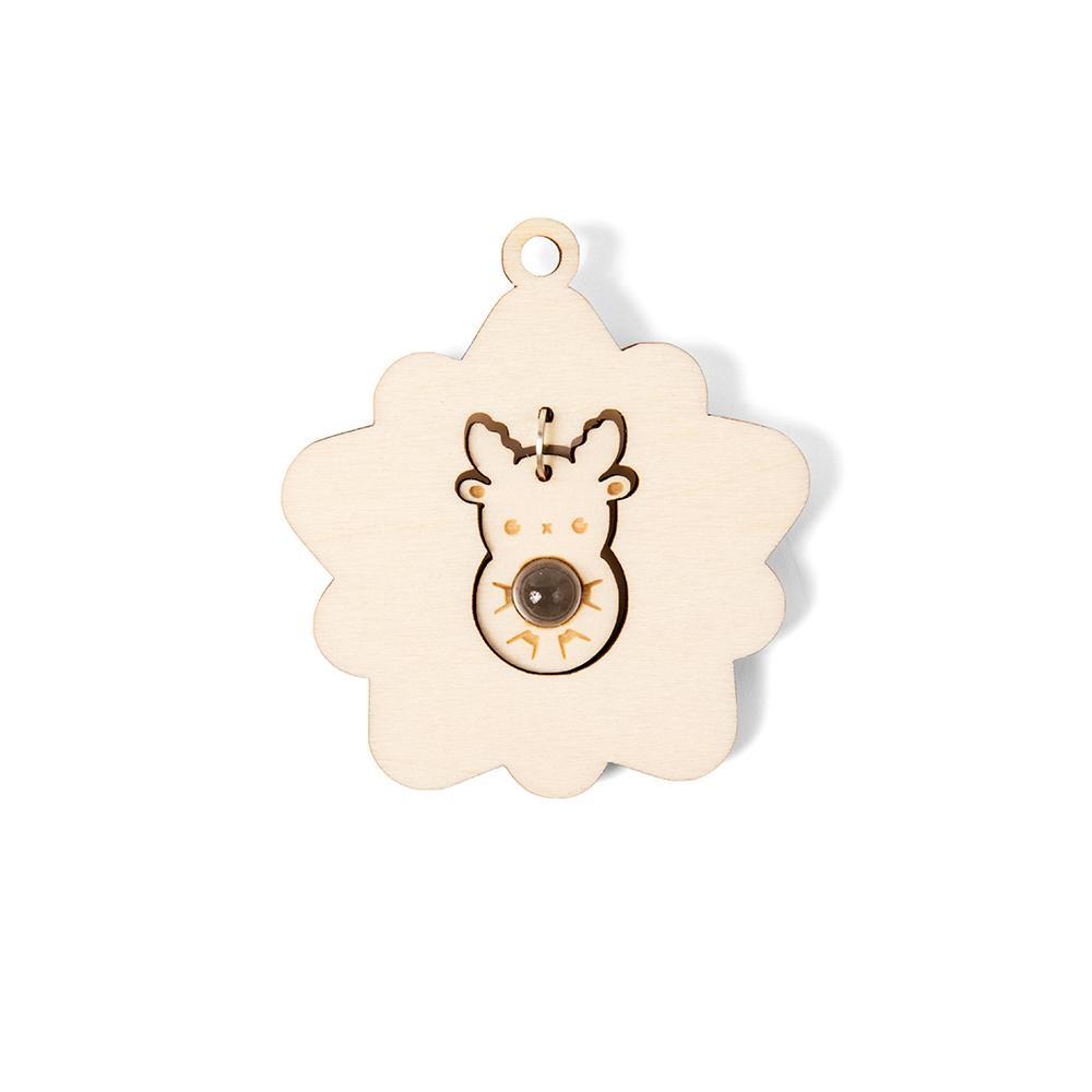 Star shaped wooden ornament with lasercut deer in the center holding clear orb.