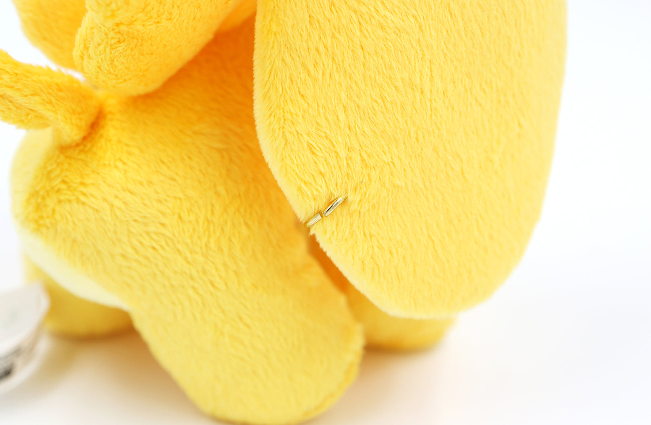Closeup detail of gold metal ring tagging the plush's ear.