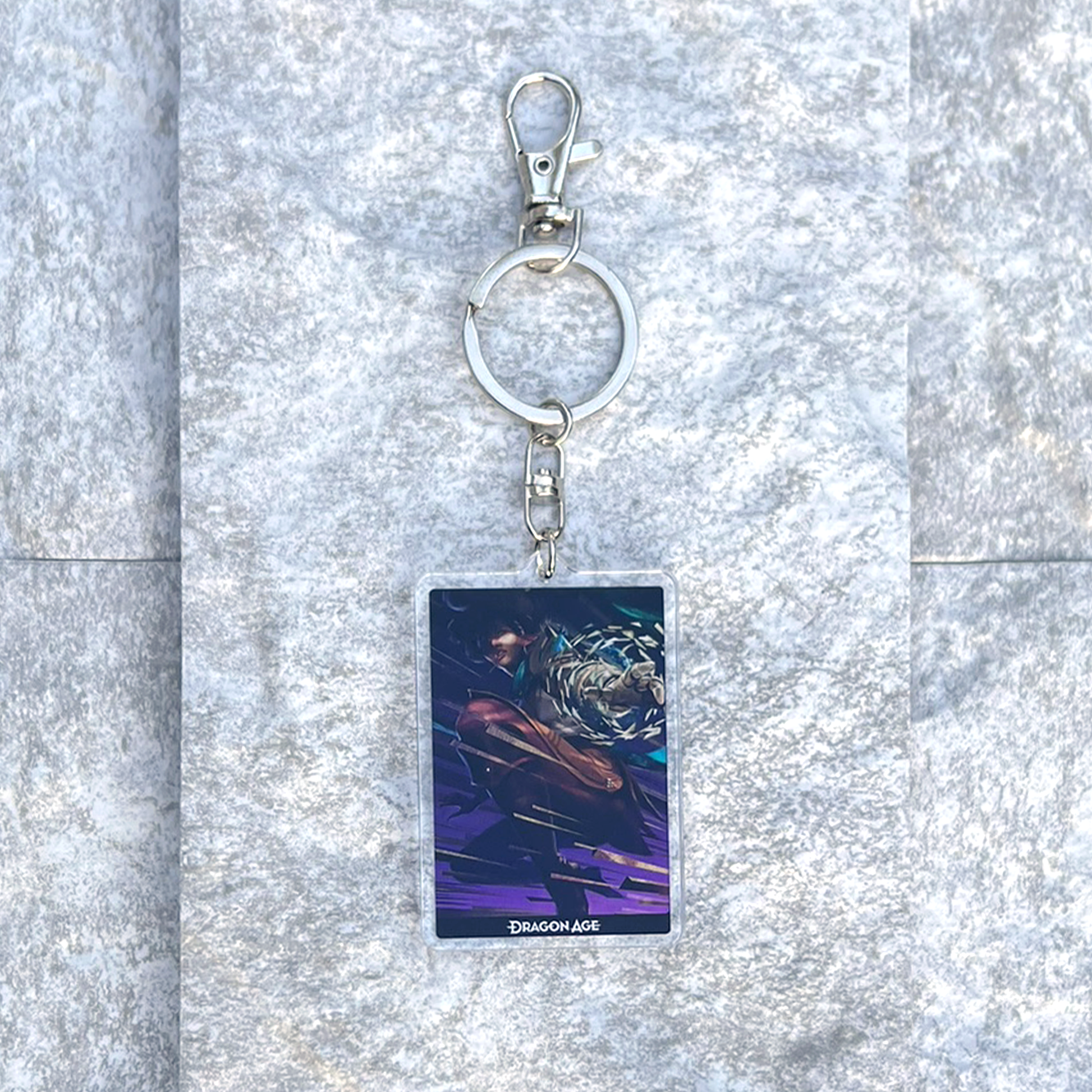 A photo from above of the Bellara acrylic keychain on white granite.