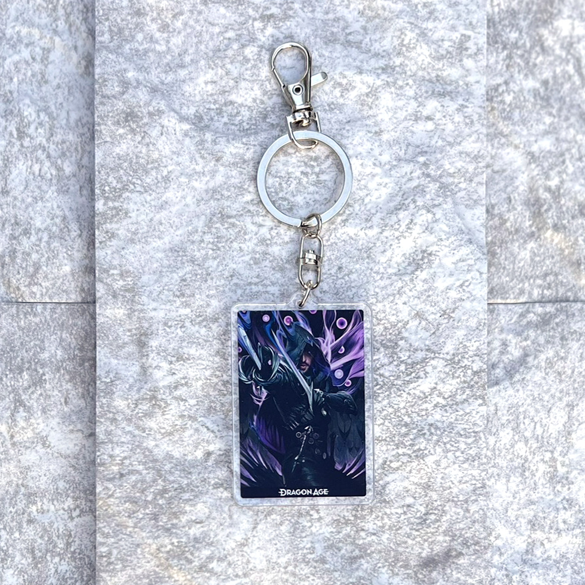 A photo from above of the Lucanis acrylic keychain on white granite.