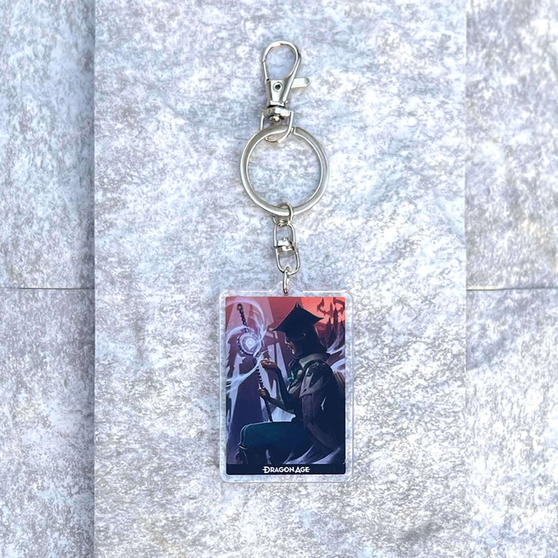 A photo from above of the Neve acrylic keychain on white granite.