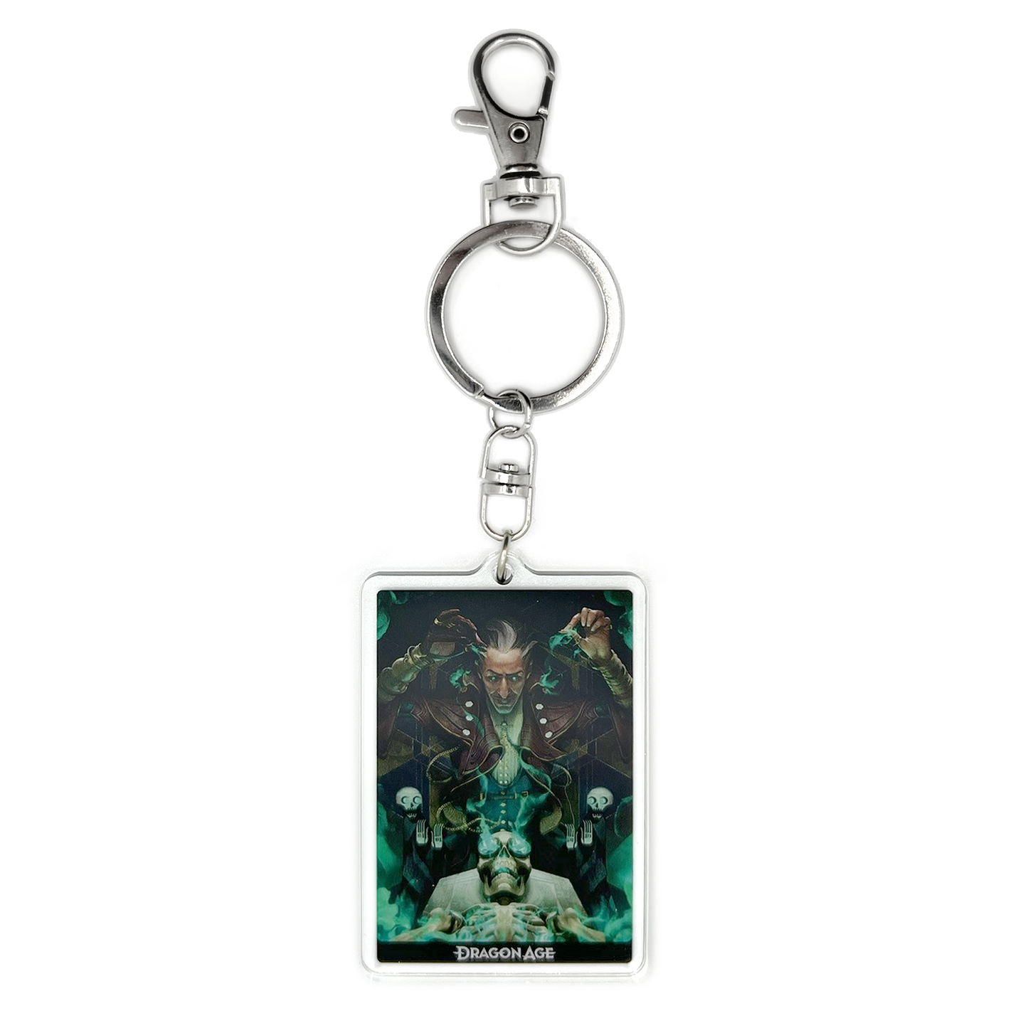 A product photo of the Emmrich acrylic keychain. The keychain is rectangular and depicts an illustration of Emmrich, leaning forward and grinning over his loyal skeleton Manfred, who is lying face up on a table. Magical green wisps surround Emmrich and Manfred, and are rising up out of Manfred’s goggled eye sockets.