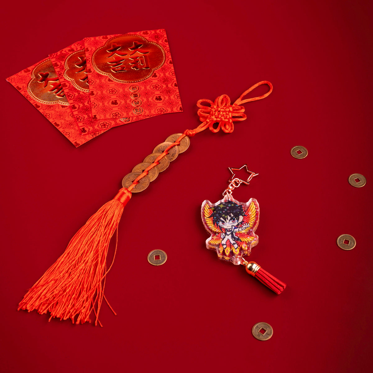 A photo from above of Side 1 of the Shimin Holographic Charm. Shimin is illustrated with his hand extended to the side, wearing a black and white outfit and fiery-colored bird wings behind them. The charm has a star shaped clasp, a red tassel, and the acrylic has a holographic effect. The charm is surrounded by scattered coins.