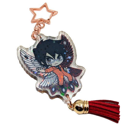A product photo of Side 2 of the Shimin Holographic Charm. Shimin is illustrated with his hand extended to the side, wearing an orange outfit and black and white bird wings behind them. The charm has a gold star shaped clasp, a red tassel, and the acrylic has a holographic effect. 