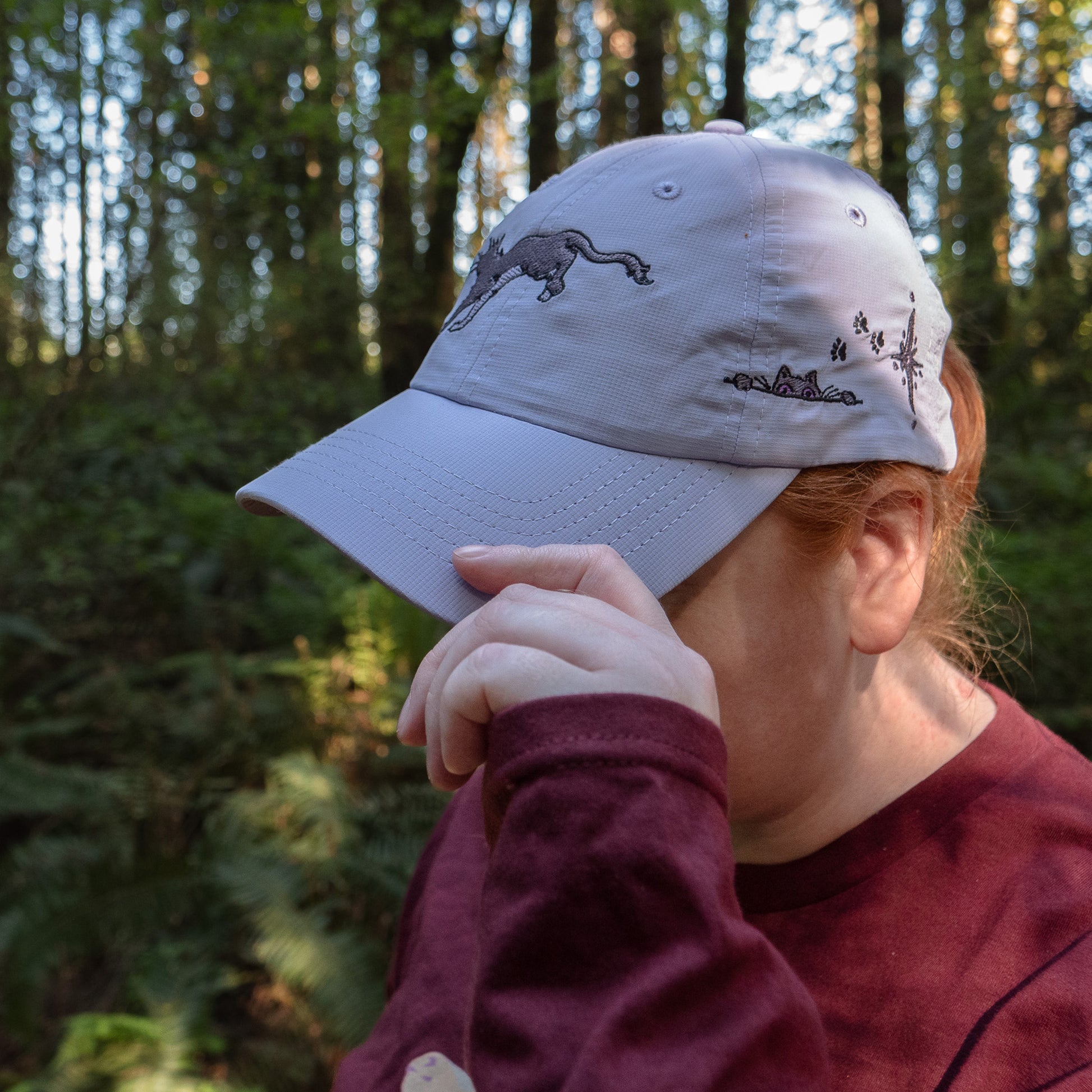 A model tipping the cap on the lavender Faithful Embroidered Hat.