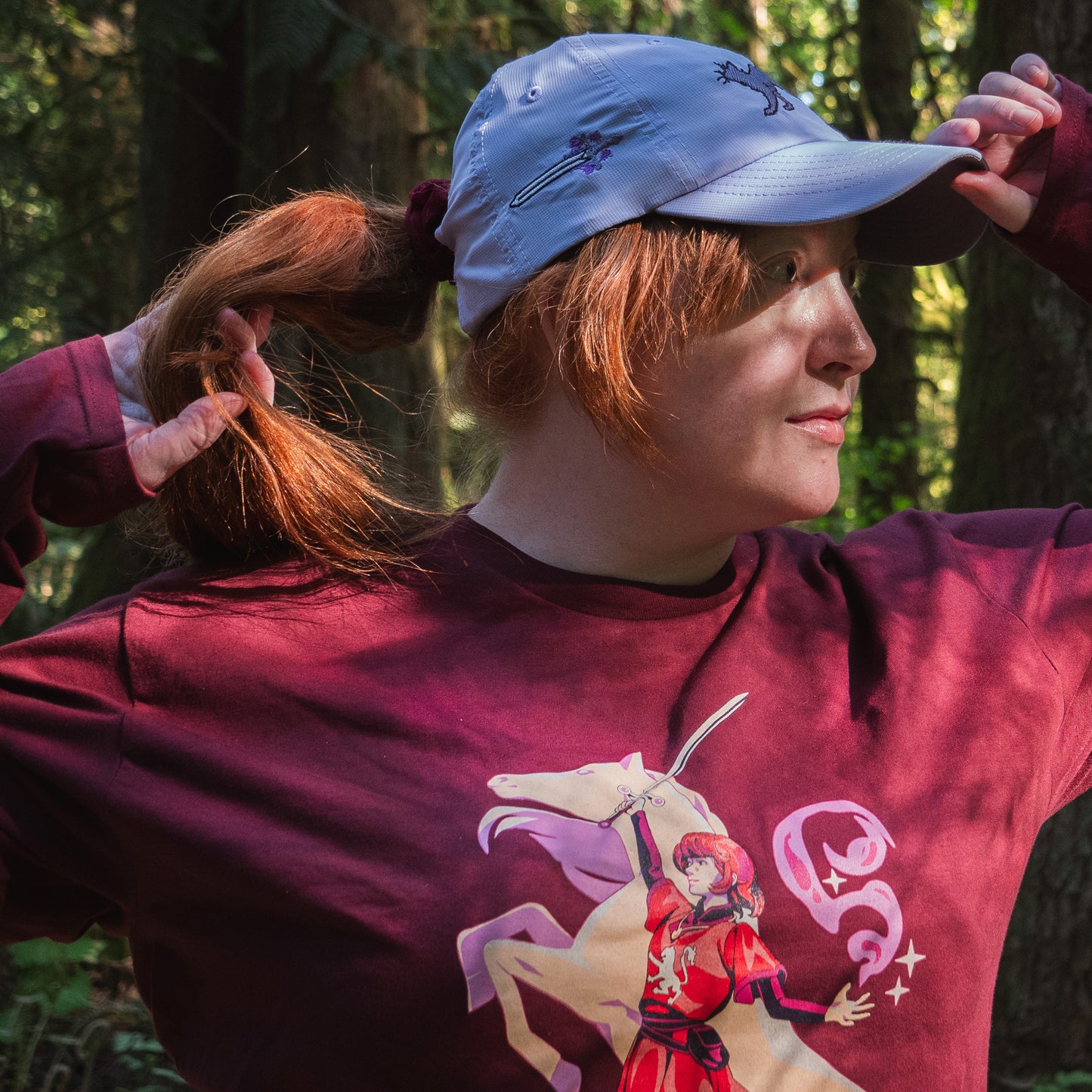 A model pulling their ponytail through the lavender Faithful Embroidered Hat