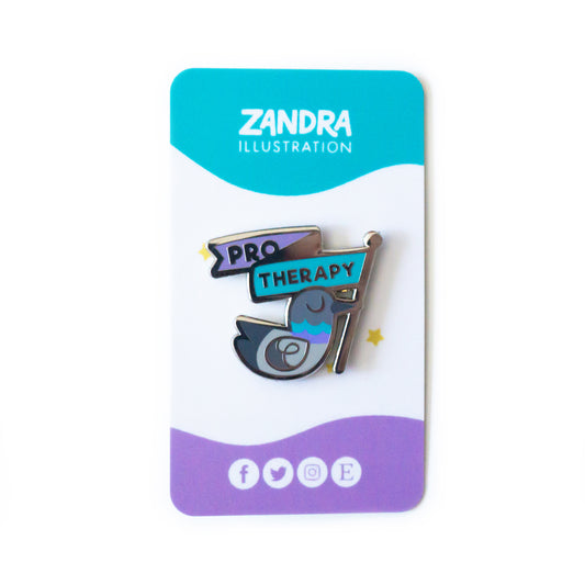 A product photo of the Pro Therapy Pigeon Pin on its cyan, white, and purple wavy colorblocked backing card. The backing card says Zandra Illustration at the top in white, and displays icons that signify the artist is on facebook, twitter, instagram, and etsy along the bottom of the card.