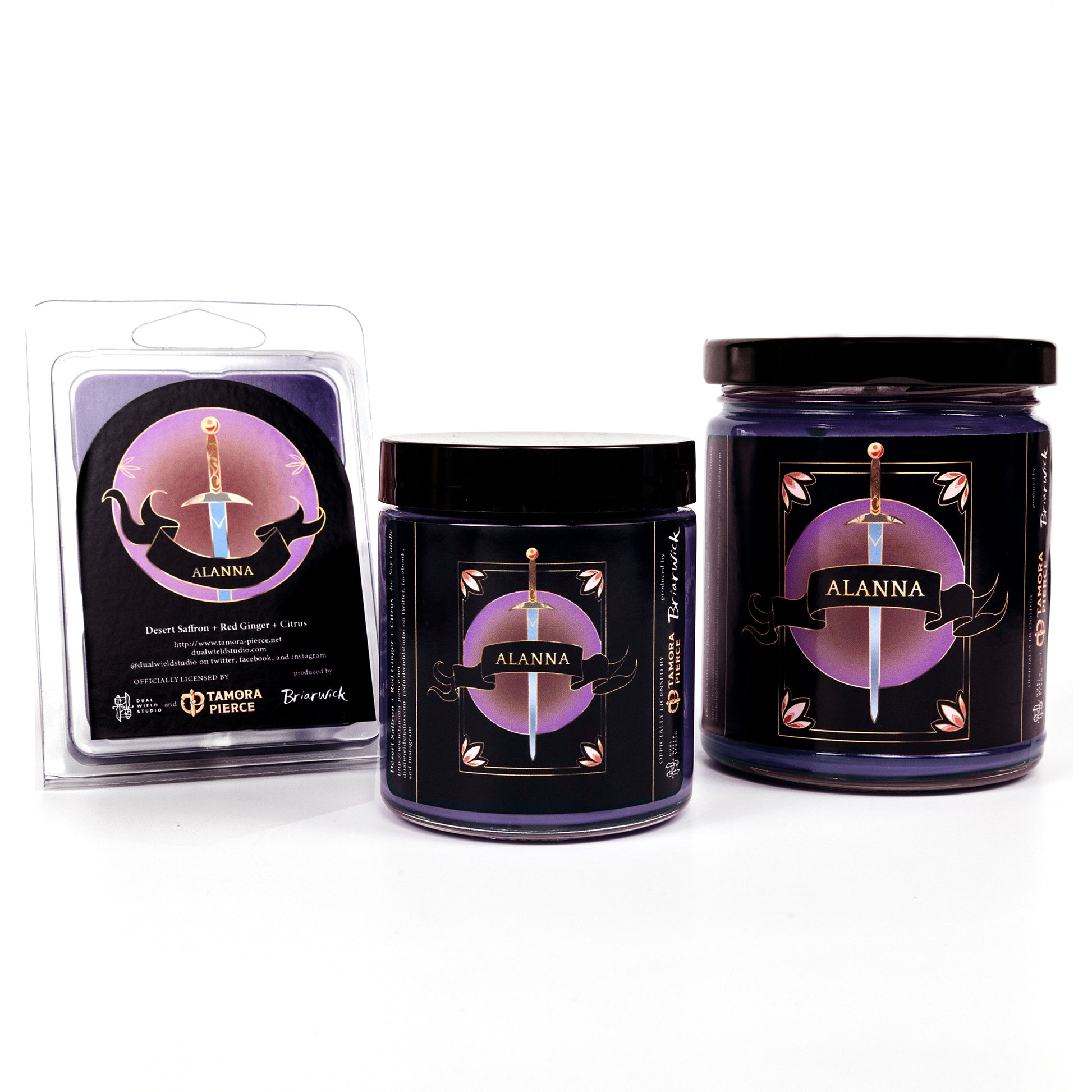 Full set of both Alanna candles and the wax melts, all with purple wax. The label is a sword at rest, with a ribbon reading "Alanna" across the center.