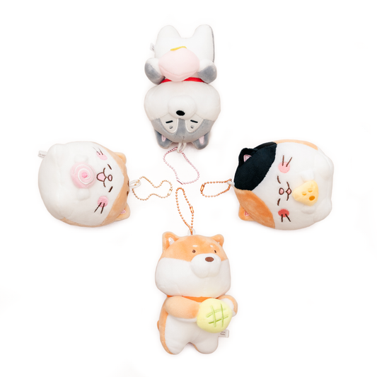 Four keyrings, two dogs and two cats, are laid out in a plus-shape.