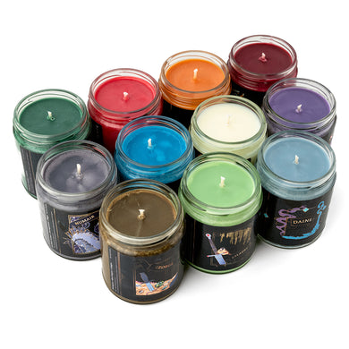 Three rows of colorful Tamora Pierce collection candles on white background.