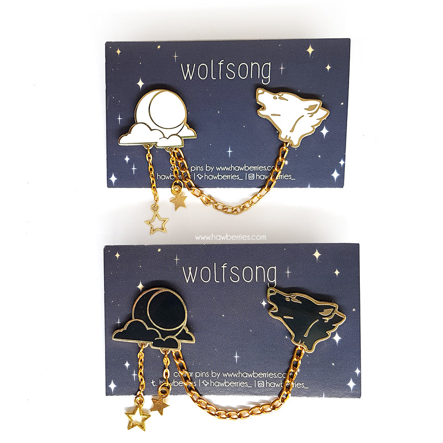 Wolf & Moon collar pins in white and black variations on starry wolfsong night backing cards.
