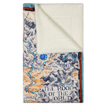 Load image into Gallery viewer, Tamora Pierce Sherpa-lined Tortall Map blanket folded into a rectangle, with the top-right corner folded over to reveal the sherpa lining.