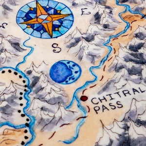 Close-up of the illustration on the blanket, showing the compass and the Chitral Pass.
