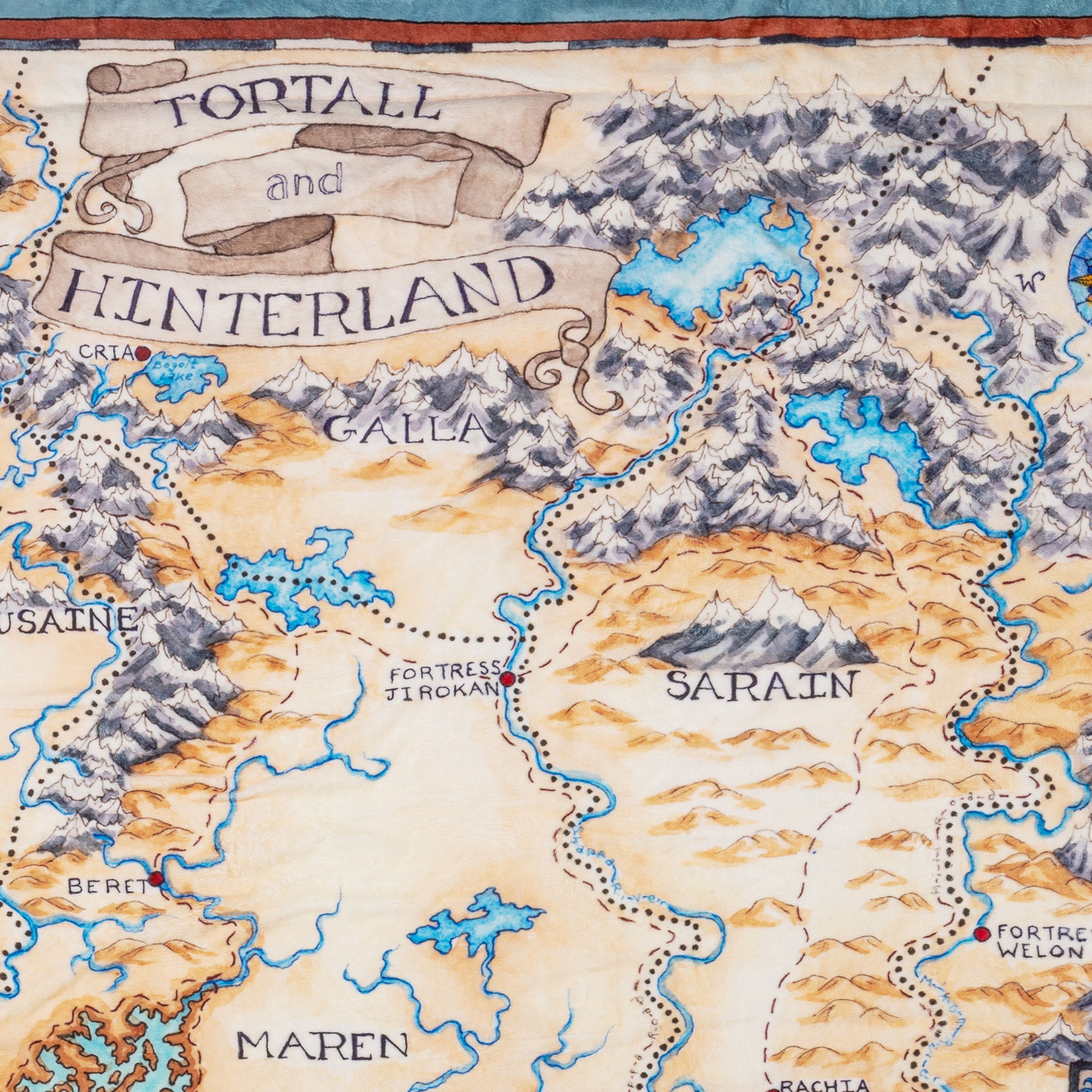 Medium shot of the illustration on the blanket, including the title "Tortall and Hinterland"