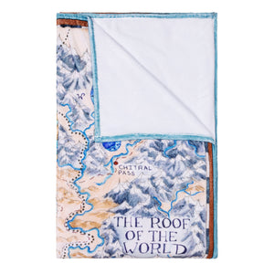 Tamora Pierce Plush Tortall Map blanket folded into a rectangle with the top-right corner folded back to show the plush white lining.