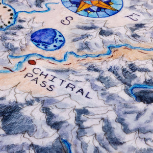 Close-up of the illusdtration on the blanket, showing the compass and the Chitral Pass.