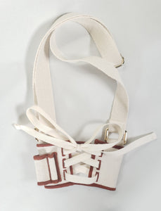 Back view of lacing on Linen color cloth cup holder with Baker Bunneh as an embroidered patch.