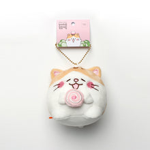 Load image into Gallery viewer, Bert (tan and white cat with pink cake roll) keyring hanging from tag on white background.
