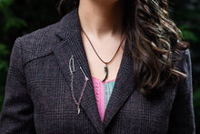 Load image into Gallery viewer, Model in grey wool blazer wearing the Daine Linked Collar Lapel Pins on their lapel and the Silver Badger Claw necklace.