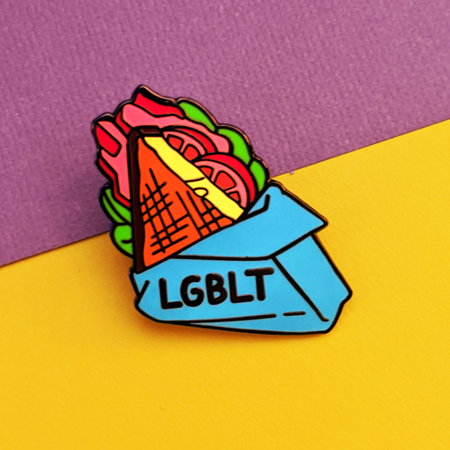 The LGBLT enamel pin shows a half wrapped BLT sandwich, with the letters LGBLT on the blue wrapping.