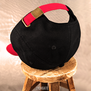 The back of the SLOPPY baseball cap has a red adjustable strap with a gold slide clasp for adjustment.