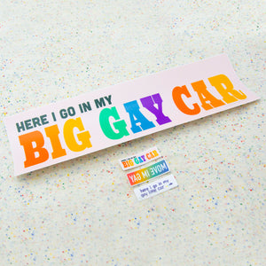 All three mini stickers together with a bumper sticker for scale. The mini stickers are extremely tiny compared to the regular sized "Here I go in my Big Gay Car" bumper sticker.
