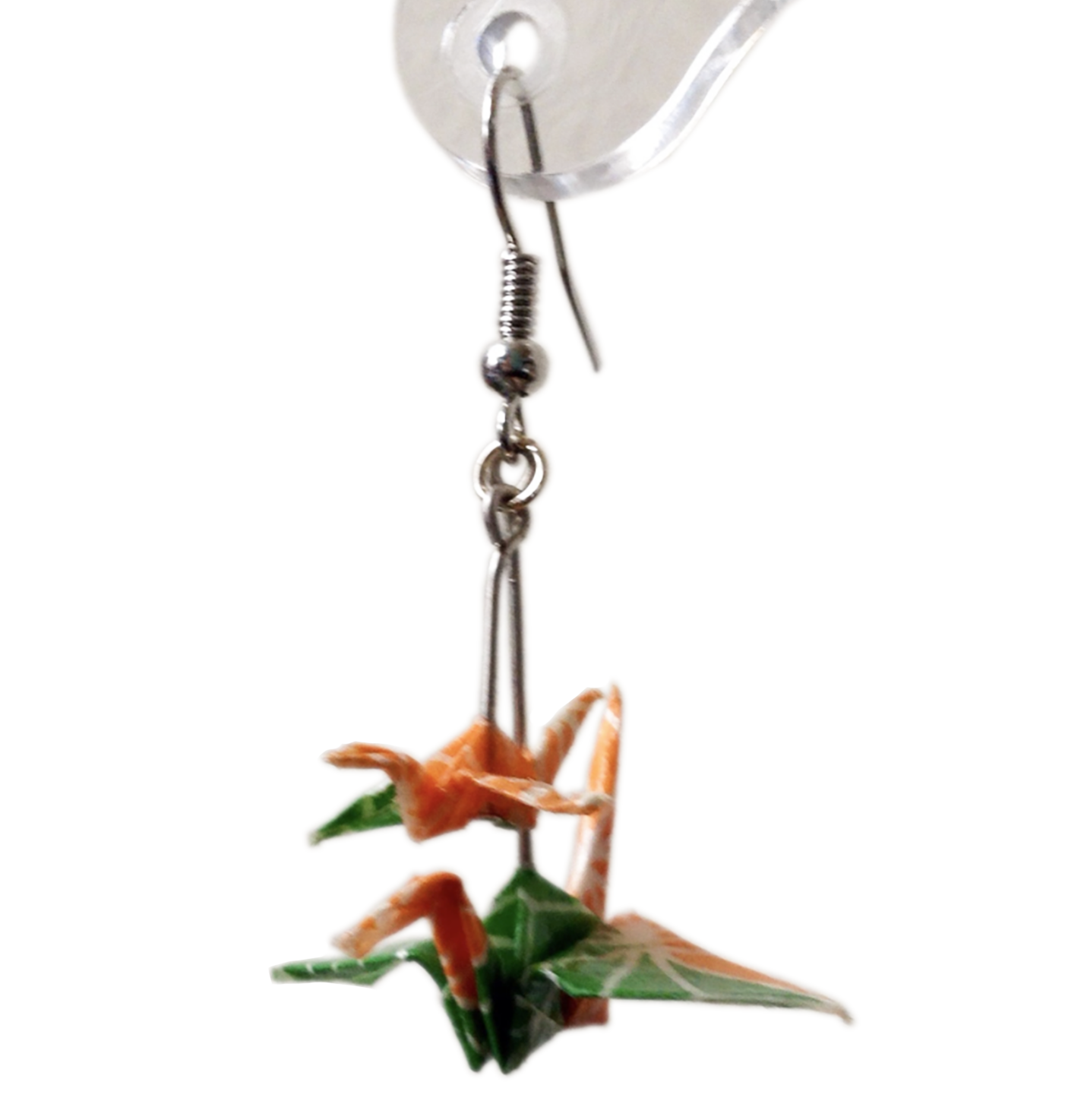 Orange and green paper crane earring on white background