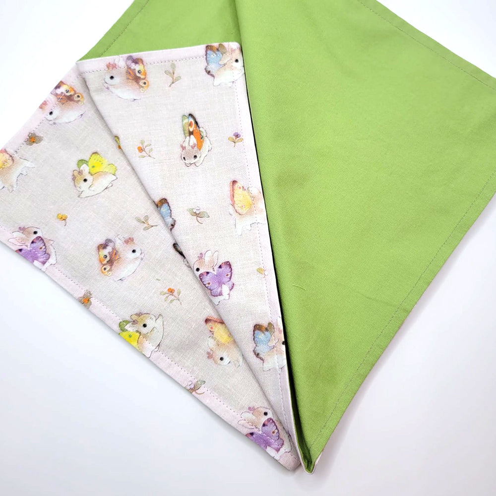 Flat view of green inside of Bunnerfly cloth furoshiki wrap on white background.