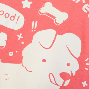 Closeup of the dog's face, licking his chops, on the Motivated By Treats t-shirt.