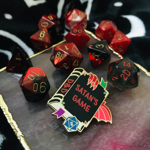 Satan's Game D&D pin with matching black and red D20 dice.
