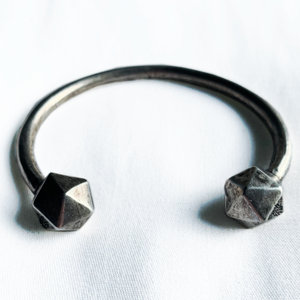Oxidized Silver D20 Dice bangle on white background.