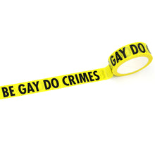 Load image into Gallery viewer, Yellow, caution-tape inspired washi tape with black &quot;BE GAY DO CRIMES&quot; text on white background