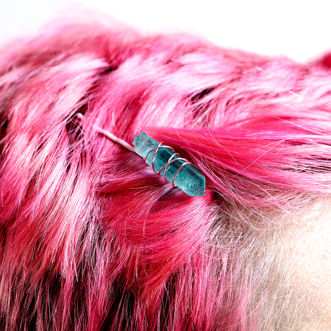 Light blue crystal on pink pin on model with pink hair.