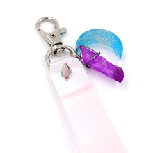 Load image into Gallery viewer, Closeup of Holographic keystrap with silver clasp and blue moon charm on white background.