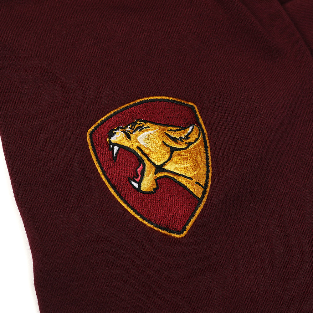 Arm detail of dark red Faithful varsity sweatshirt. Decal is roaring lioness in profile framed by marigold and red shield shape.