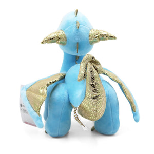 Back/tail view of light blue and metallic gold detailed Skysong dragon plush stands, looking upward, on white background.