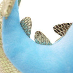 Closeup of Skysong plush tail with metallic scutes.