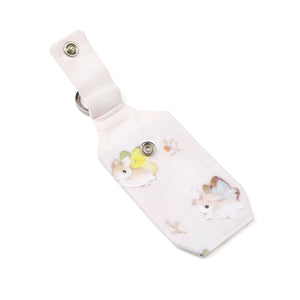 Open pastel pink bunnerfly hand sanitizer holder on white background.