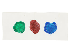 Each of the sealed waxes on a white piece of paper.