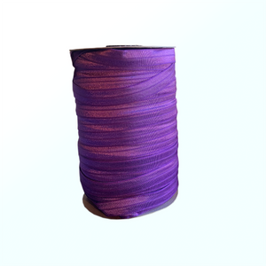Spool of purple elastic on white background.
