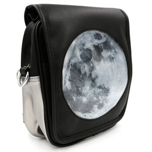 Side view of black Moon Ita back with round Moon insert on white background.
